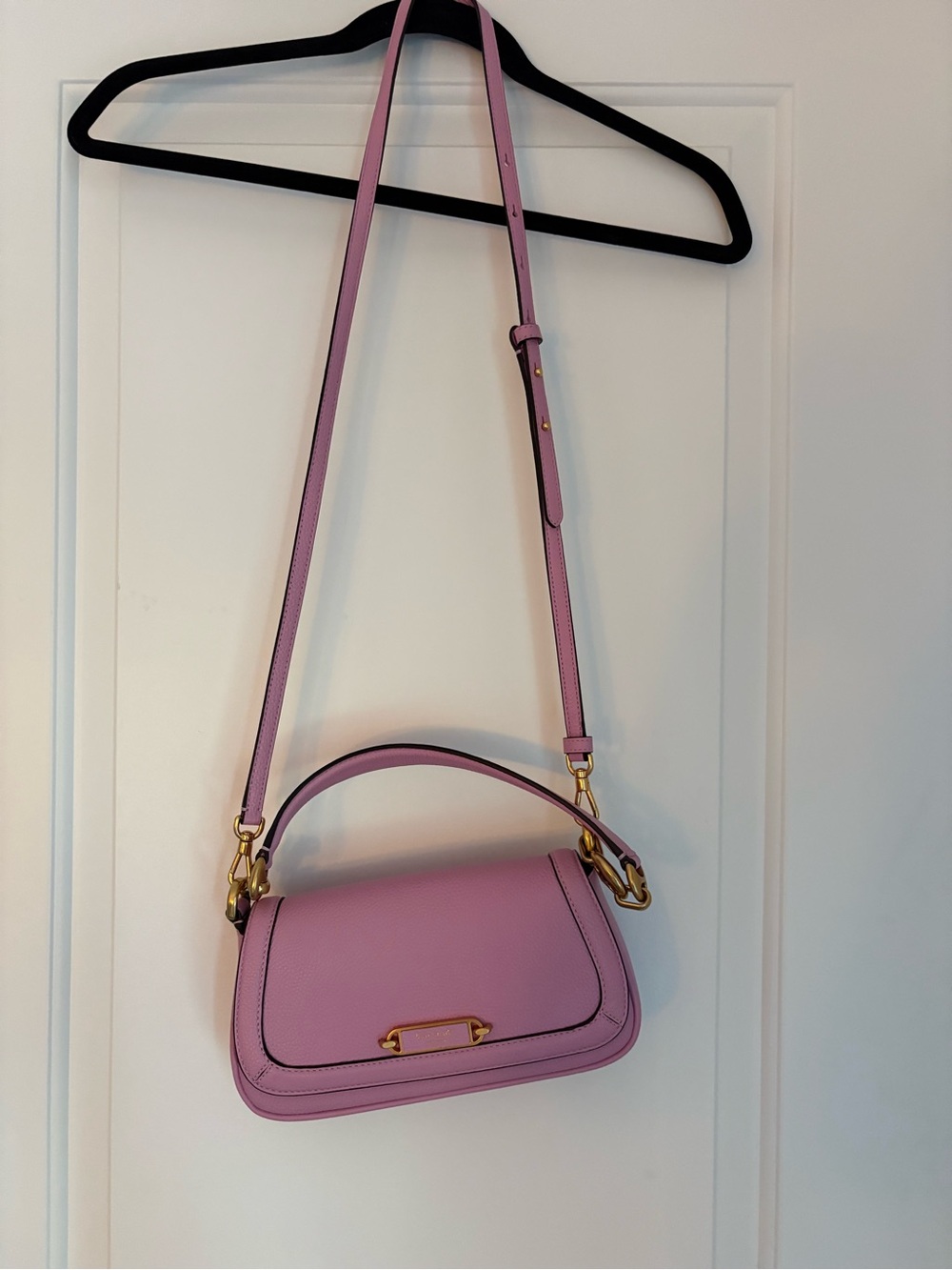 Kate Spade Pink Leather Crossbody Bag with wrist strap.